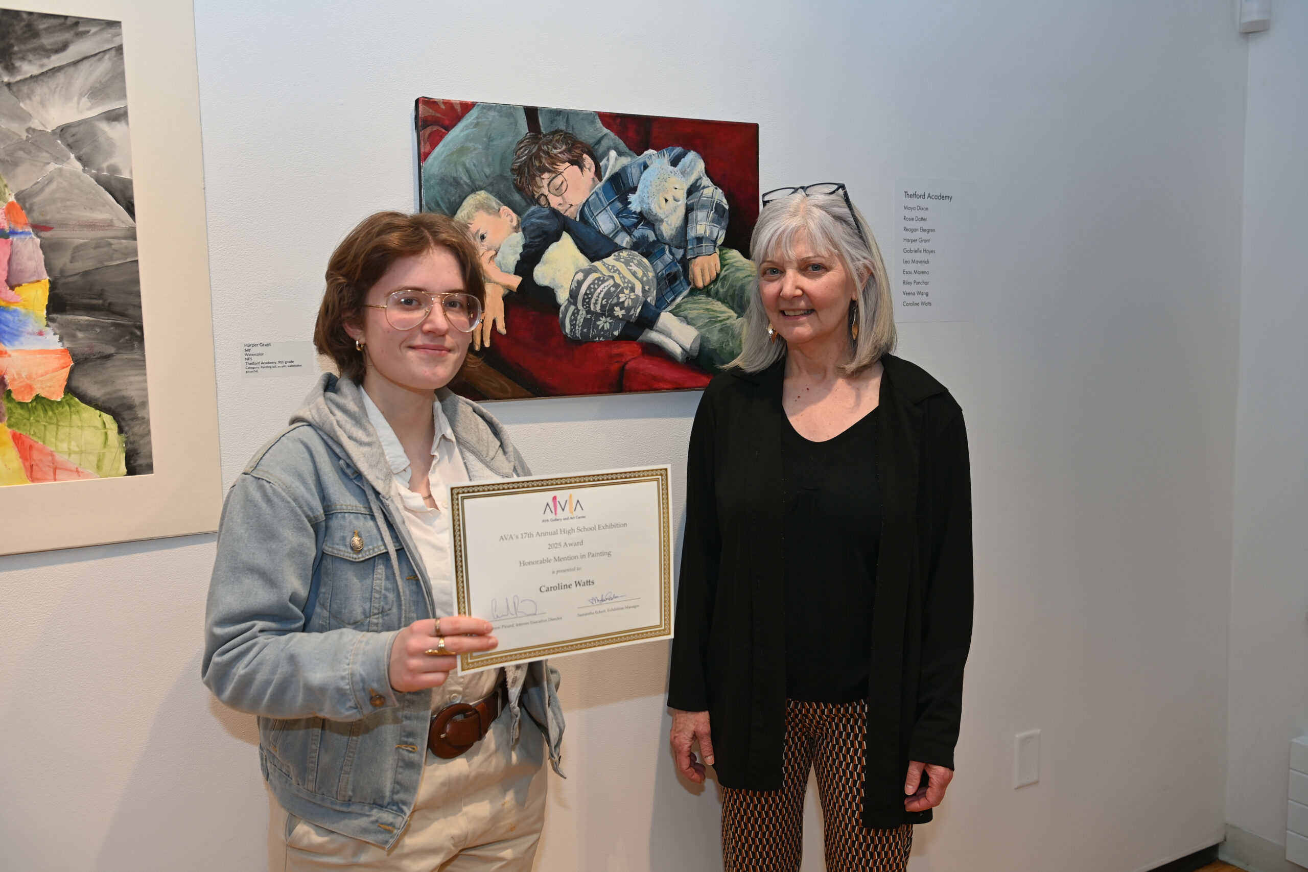 Student Caroline Watts and art teacher Karyn Neubauer pose with Caroline's painting and honorable mention certificate.